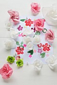 Paper roses on paper printed with flowers