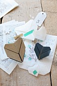 Origami hearts and washi tape on printed paper