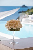 Arrangement of white roses on cake stand