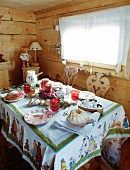 Festively set table in rustic wooden cabin