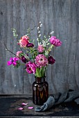 Vase of spring flowers (tulips, ranunculus, anemones, scabious, pussy willow catkins)