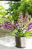 Summer bouquet of lupins on garden table