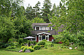 Swedish house surrounded by lush garden