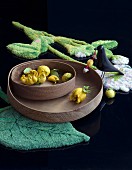 Lemons on wooden trays on leaf-shaped rig