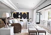 Modern artworks in elegant country-house-style lounge with open terrace doors