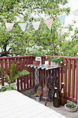 Bunting above old sewing-machine table on balcony