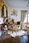 Anitk desk and wing chair on animal fur rug in vintage ambience