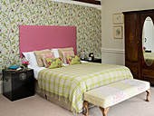 Floral wallpaper in romantic bedroom in shades of green and pink