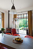 View across concrete dining table through industrial-style terrace doors