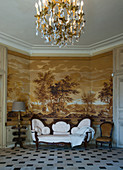 Antique sofa against sepia wallpaper with landscape motif