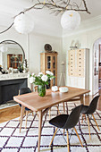 Bright dining room in natural shades in period apartment with open fireplace