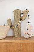 Paper garland on cactus ornament made from woven raffia