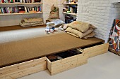 Drawers below platform and cushions made from old hessian sacks