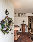 View past wreath on white front door into vintage cafe