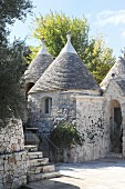 Traditional trullo houses below blue sky
