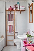 Colourful accessories in white bathroom with mosaic tiles