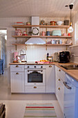 Wall-mounted shelves in romantic country-house kitchen
