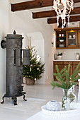Cast-iron stove and Christmas decorations in country-house kitchen