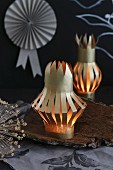 Concertina lanterns hand-crafted from gold paper decorating table