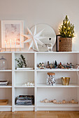 Christmas decorations on half-height white shelves