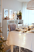 Festively decorated table set with white cloth and decorations