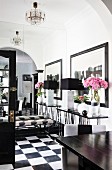 Mirrored wall in black and white foyer