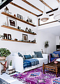 Shelf boards above the sofa in the living room with boho flair