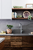 Modern kitchen with natural wooden fronts and gray tiles