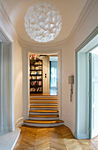 Oval hallway with curved walls and steps leading to higher level