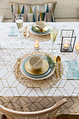 Christmas table set in cool winter colours and gold