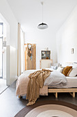Bright bedroom in shades of white and brown
