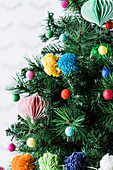 Pleated ornament and colorful pompoms as Christmas tree decorations