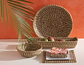 Set of seagrass baskets of different shapes against orange wall