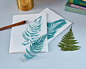 Fern leaves used as template for greetings card with natural motif