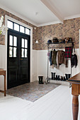 Black panelled door in English-style foyer