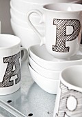 White cups with black shaded block letters