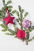 Various hand-made decorations wrapped in wool on green fir branch