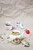 Sewing supplies in old teapot and sugar bowl