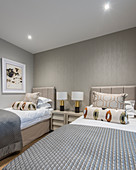Twin beds in bedroom in shades of grey