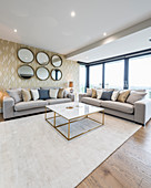 Glamorous living room in shades of Champagne with glass wall