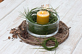 Lantern with wreath of Cytisus branches in wide glass