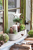 Natural Advent decoration in front of window with pinus branches