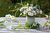 Small meadow bouquet with Bellis perennis, grasses