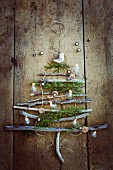 Rustic Christmas tree made from twigs on wooden wall