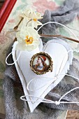 Old brooch on hand-sewn fabric heart