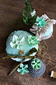 Arrangement of ornaments and green origami flowers