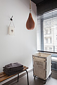 Punchball suspended above laundry basket and bench in bathroom