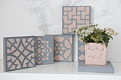 Hand-made, concrete-effect tiles with stencilled patterns