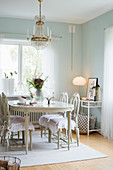 Antique Swedish dining table and chairs in dining room with mint-green walls