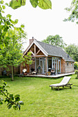 Lawn and large summerhouse with terrace in well-tended garden